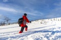 Woman in red sports jacket savors snow and breathtaking Norwegian landscape
