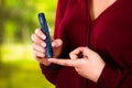 Woman with red sweater checking blood sugar level by glucometer and test stripe at home Royalty Free Stock Photo