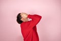 Woman in red sweater covering her face with hands. Concept of fear, shame, domestic violence. Royalty Free Stock Photo