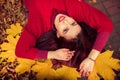 Woman in red sweater portrait with yellow maple leafs Royalty Free Stock Photo