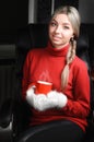 Woman in red sweater and white mittens holding cup Royalty Free Stock Photo