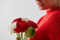 Woman in a red sweatshirt with flowers Buttercup on a white background. Royalty Free Stock Photo