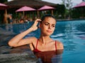 woman in red swimsuit Swimming in the pool vacation landscape hotel