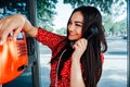 a woman in red talking on the phone in a phone booth Royalty Free Stock Photo