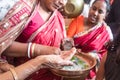 Woman in red mekhla holding religious offering