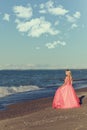 Woman in red tulle evening dress by ocean Royalty Free Stock Photo