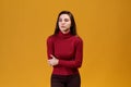 A woman in a red turtleneck holds her stomach. The girl has a stomach ache. From severe pain beautiful young woman wants to cry Royalty Free Stock Photo