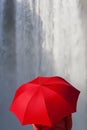 Woman With a Red Umbrella In Front Of A Waterfall Royalty Free Stock Photo