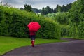 Woman with red umbrella on an overcast day. Royalty Free Stock Photo