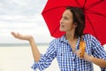 Woman with red umbrella touching the rain Royalty Free Stock Photo