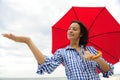 Woman with red umbrella touching the rain Royalty Free Stock Photo