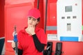 Woman with red uniform at the gas station for service Royalty Free Stock Photo