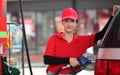 Woman with red uniform at the gas station for service Royalty Free Stock Photo