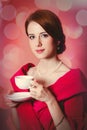 Woman in red Victorian epoch clothes with cup of tea Royalty Free Stock Photo