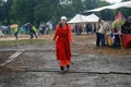 Woman in red walks under the rain without umbrella