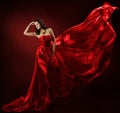 Woman in red waving dress with flying fabric Royalty Free Stock Photo