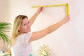 Woman redecorate home and working with folding yardstick