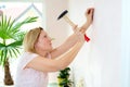 Woman redecorate home and working with hammer