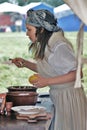 Woman reenactor cooking dinner