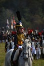 Woman reenactor rides a horse at Borodino battle historical reenactment in Russia