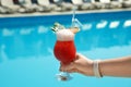 Woman with refreshing cocktail near swimming pool outdoors Royalty Free Stock Photo
