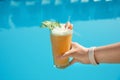 Woman with refreshing cocktail near swimming pool outdoors Royalty Free Stock Photo