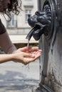 Woman is refreshing at fountain in sweltering hot days Royalty Free Stock Photo