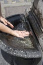 Woman is refreshing at fountain in sweltering hot days Royalty Free Stock Photo