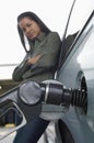 Woman Refueling Car At Gas Station