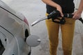 Woman refuelling car Royalty Free Stock Photo