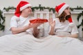 Woman refuses a gift on a bed decorated for Christmas on New Year E