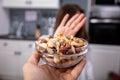 Woman Refusing Bowl Of Nut Food