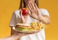 Woman Refusing Plate With Unhealthy Food And Choosing Apple Royalty Free Stock Photo