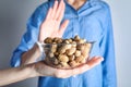 Woman refusing to eat peanuts. Food allergy concept