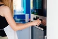 Woman regulates the temperature of the oven - 250C. Royalty Free Stock Photo