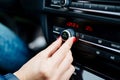 Woman regulating car air condition. Royalty Free Stock Photo