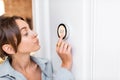 Woman regulating heating temperature with a smart thermostat Royalty Free Stock Photo