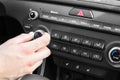 Woman regulating temperature on car air condition. Modern car interior Royalty Free Stock Photo