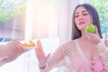 Woman rejecting junk food fried chicken for unhealthy food for healthy lifestyle and eat apple instead