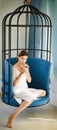 Woman relax in cage chair at home. matcha tea ceremony of girl in cage chair. perfect morning with coffee. pretty woman Royalty Free Stock Photo