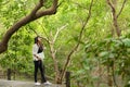 Woman relax and chill while listening music with headphone and laptop in the outdoor education nature green park, girl happy. Royalty Free Stock Photo