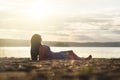 Woman relax and lay down in the sunset on the beach. Royalty Free Stock Photo