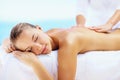 Woman, relax and massage for back with spa therapist for wellness, holistic therapy or cosmetic care at holiday resort Royalty Free Stock Photo