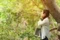 Woman relax and reading a book while listening music with headphone in the nature green park, girl happy. Royalty Free Stock Photo