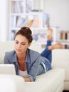 Woman, relax and sofa with laptop for internet, social media and research for indoor or at home. Young person, lady and Royalty Free Stock Photo