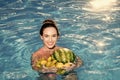 Woman relax in spa pool. Dieting and healthy organic food, vegetarian. Vitamin in banana at girl sitting near water Royalty Free Stock Photo