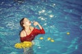 Woman relax in spa pool. woman with tropical fruit in pool. Vitamin in banana at girl sitting near water. Dieting and Royalty Free Stock Photo