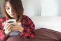 Woman relaxed on bed with cup of coffee in hands, top view..morning, leisure, people concept - happy young woman drinking coffee