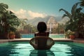 A woman relaxes on a chair in front of a serene pool, A top view captures a young African American woman using a laptop while Royalty Free Stock Photo