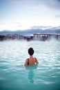 Woman relaxes and enjoys of spa in hot spring Blue Lagoon in Ice Royalty Free Stock Photo